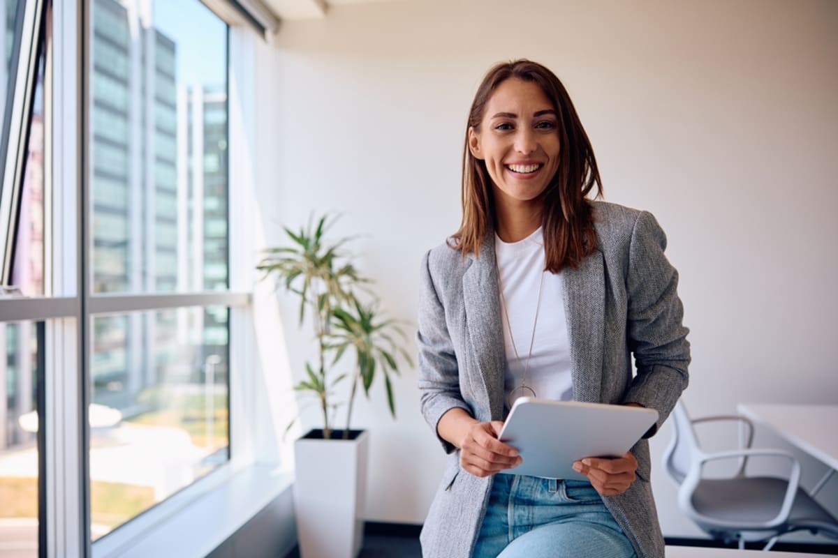 A happy digital marketer holding a tablet