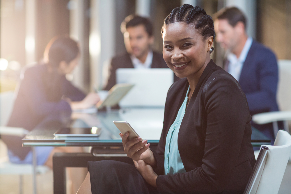 Portrait of businesswoman holding mobile phone in the office